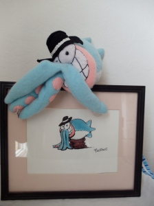Mr. Squid by Omnidoll, from Piranha Club, posing with original art by the cartoonist Bud Grace.
